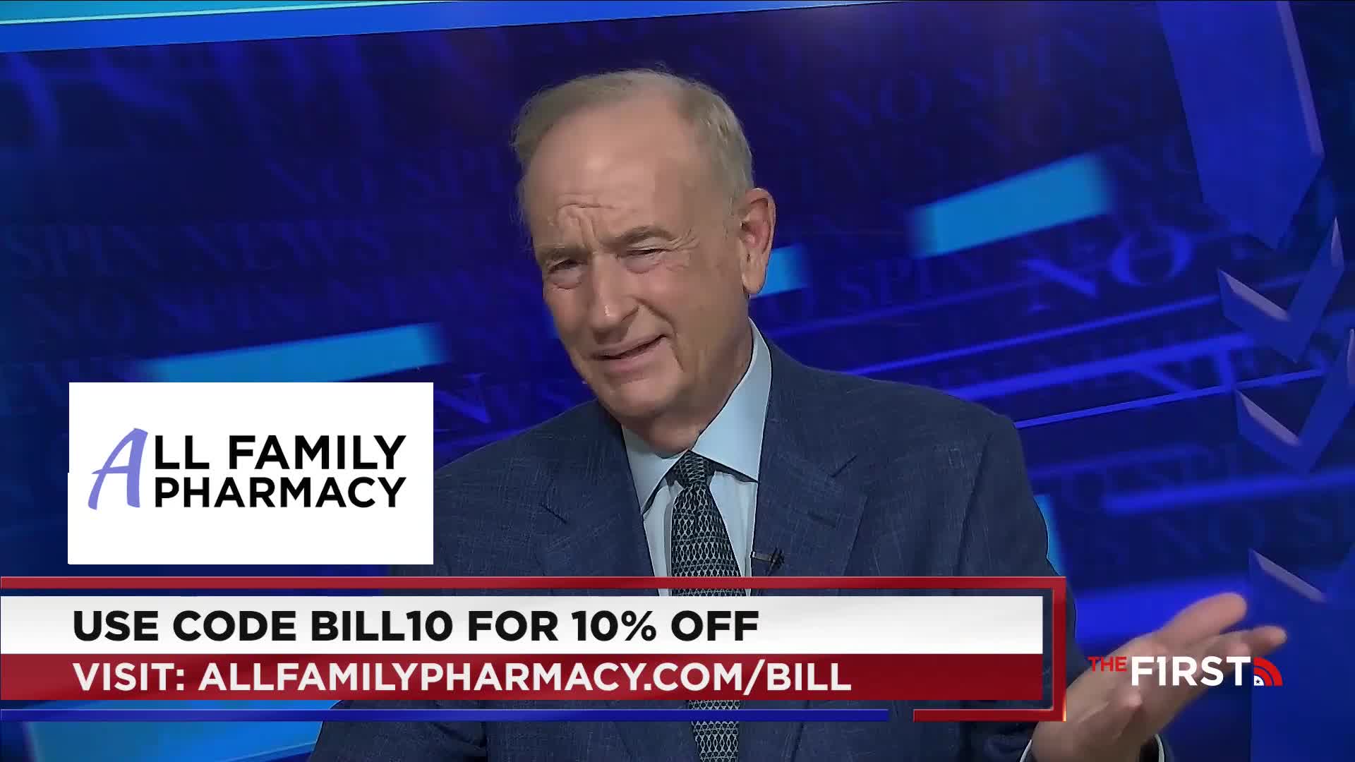 A man in a suit, from The First TV in the United States, is gesturing with his right hand. Below, a promotional banner advertises All Family Pharmacy.
