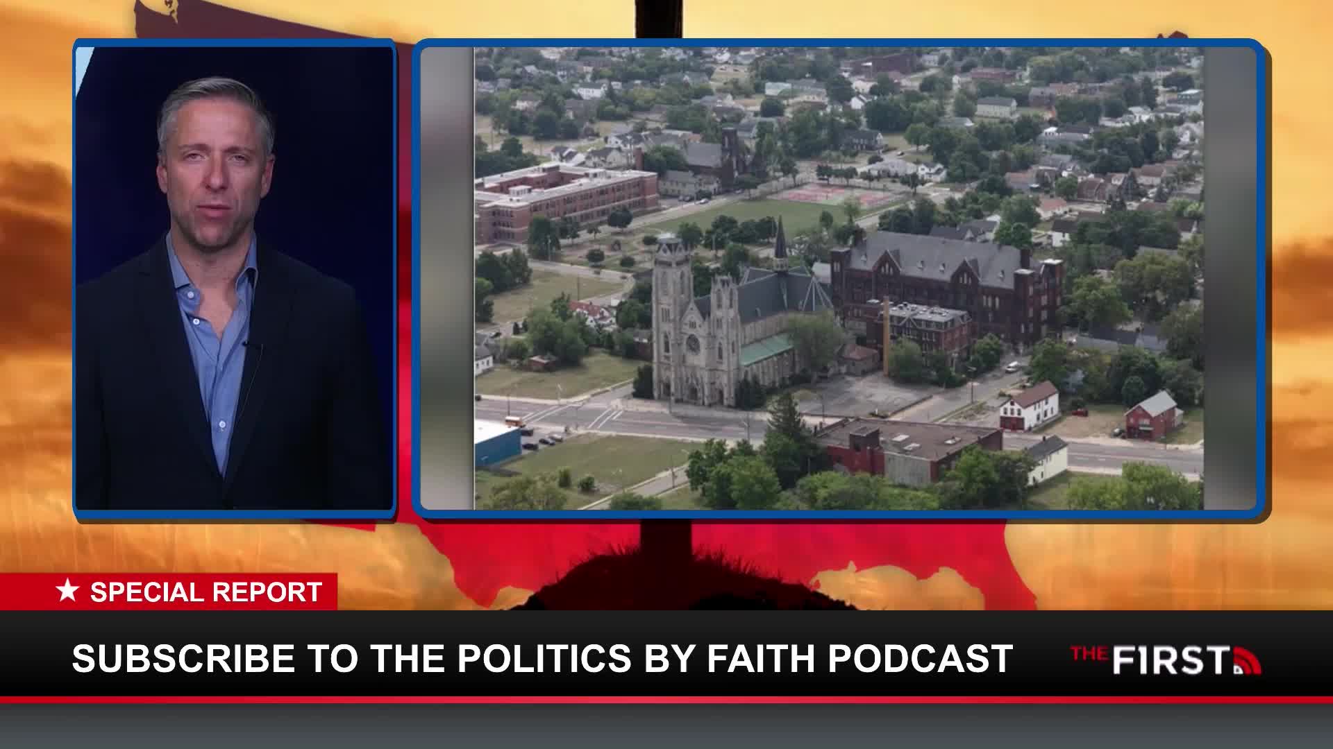 A man in a suit is speaking on The First TV, with a bird's-eye view of a town in the United States displayed beside him. The scene shows a church and other buildings, set against a backdrop that resembles a sunset.
