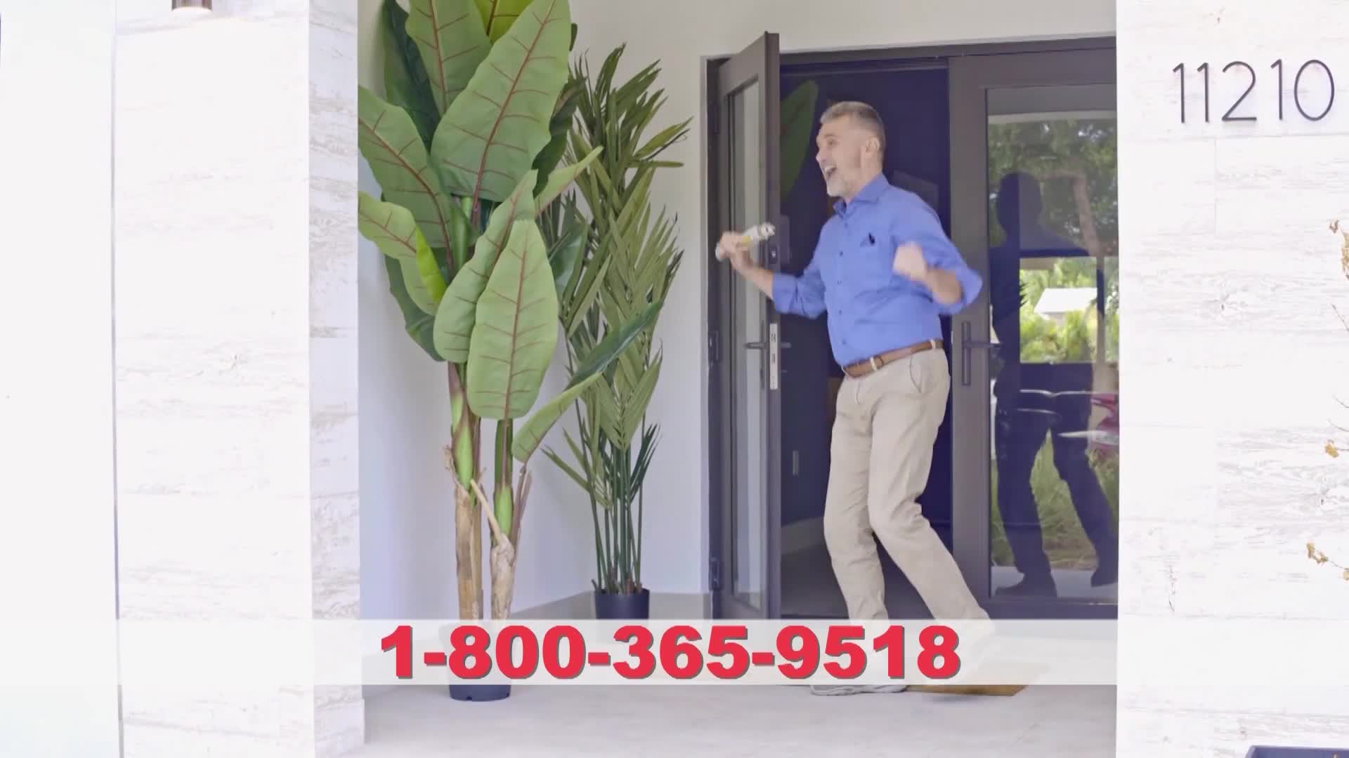 A man, holding something in his hand, bursts out of a doorway, arms raised in celebration. The scene is set outside a house, with a phone number displayed prominently at the bottom.
A man, holding something in his hand, bursts out of a doorway, arms raised in celebration. The scene is set outside a house, with a phone number displayed prominently at the bottom.