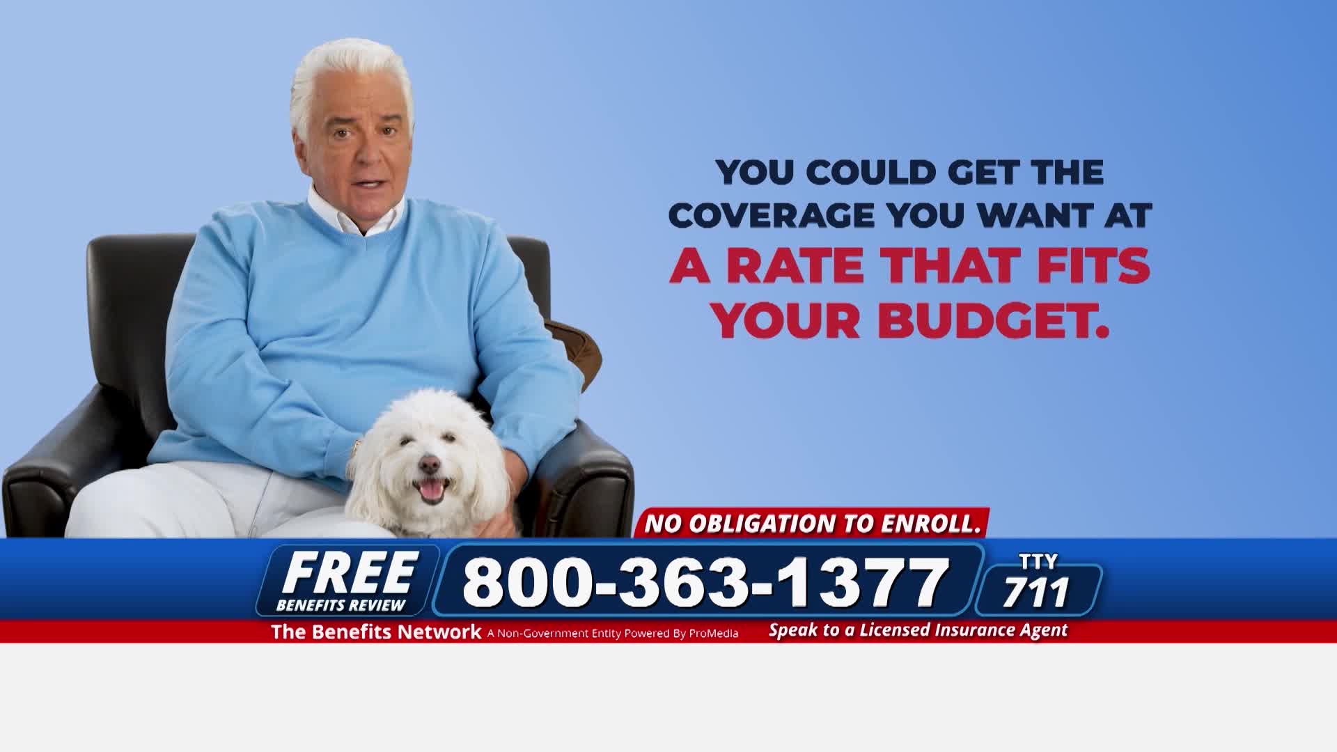 A man in a blue sweater sits in a chair with a fluffy white dog in his lap. Beneath them, a phone number and the words "Benefits Review" flash across the screen, likely a commercial on The First TV.
A man in a blue sweater sits in a chair with a fluffy white dog in his lap. Beneath them, a phone number and the words "Benefits Review" flash across the screen, likely a commercial on The First TV.