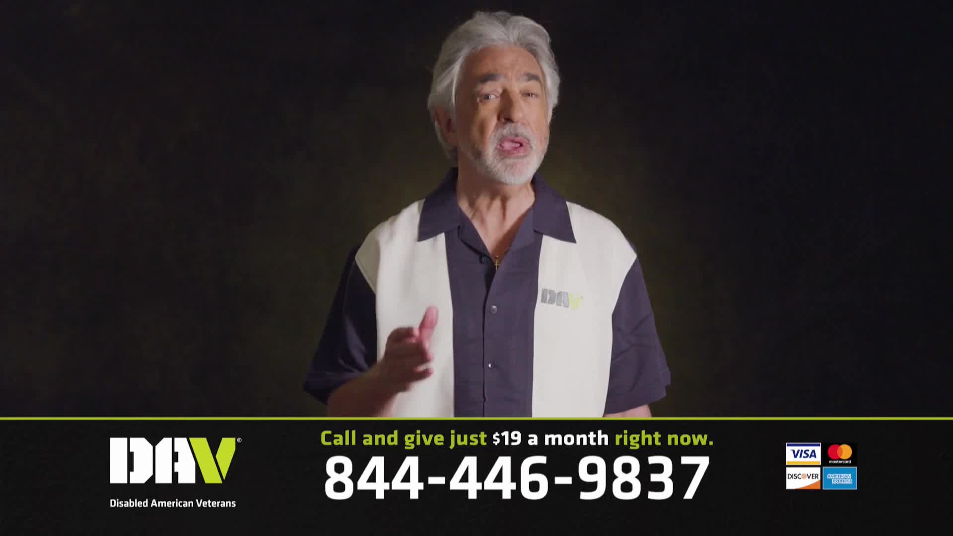 A man with gray hair and a goatee speaks directly to the camera, gesturing with his left hand. Below him, a green and black banner displays the DAV logo, a phone number, and credit card logos.