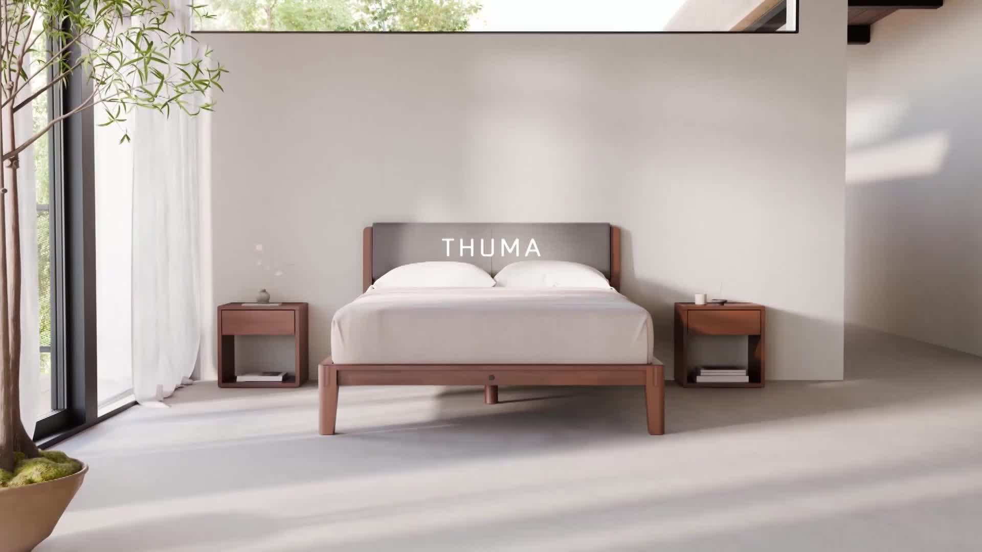 Sunlight streams across the floor, illuminating a simple wooden bed with a gray headboard. Two matching nightstands flank the bed, each holding a small white object.