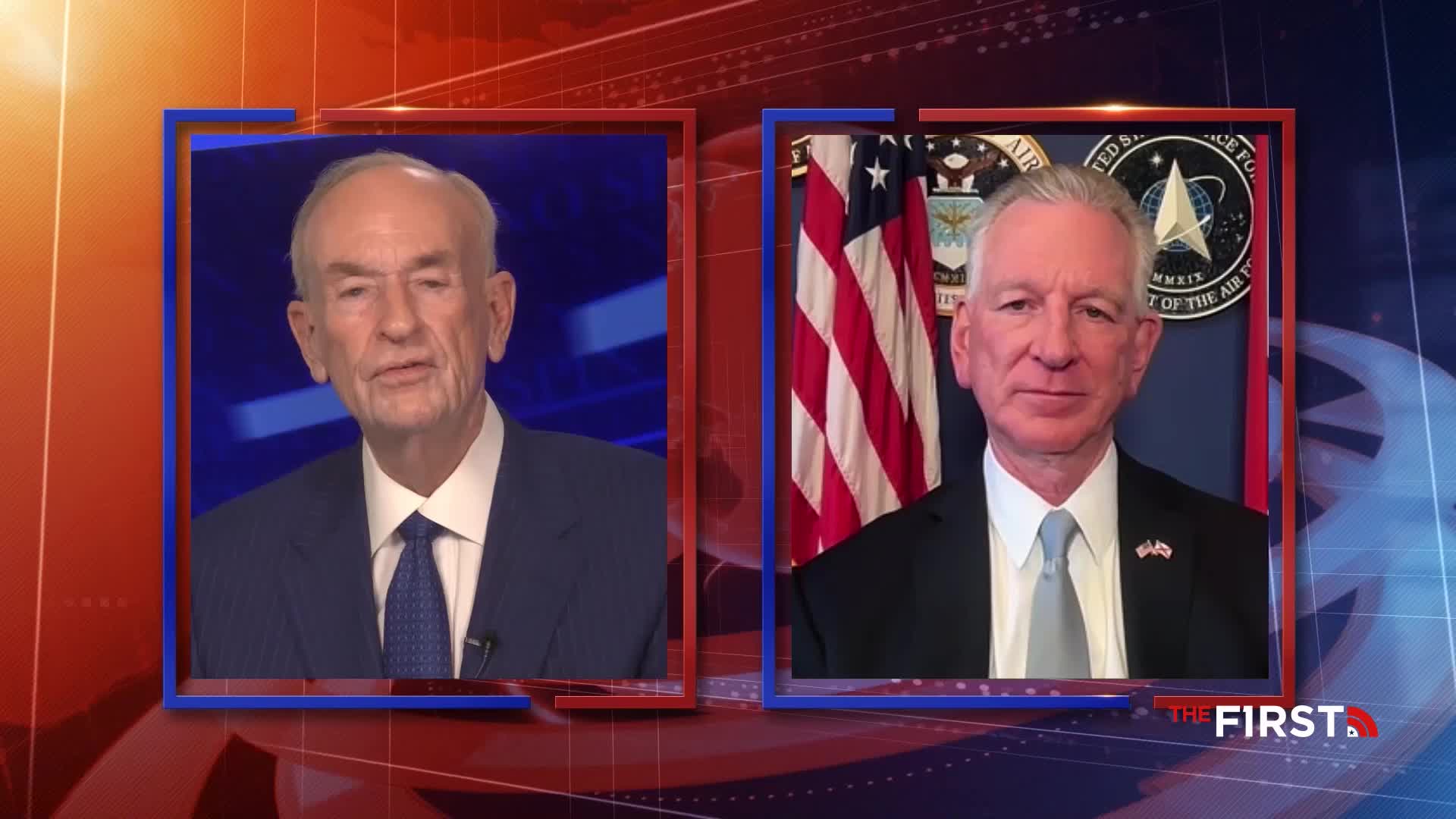 Two men, one in a blue suit and the other in a dark suit with a light tie, appear in separate video feeds. The man on the right is positioned in front of an American flag and the U.S. Air Force emblem.
