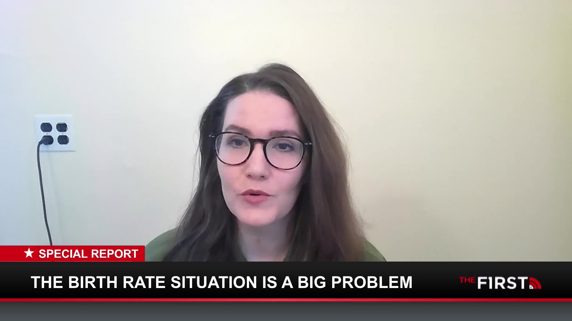A woman with glasses speaks directly to the camera, her words appearing on a chyron below that reads "THE BIRTH RATE SITUATION IS A BIG PROBLEM." The First TV logo is visible in the corner.