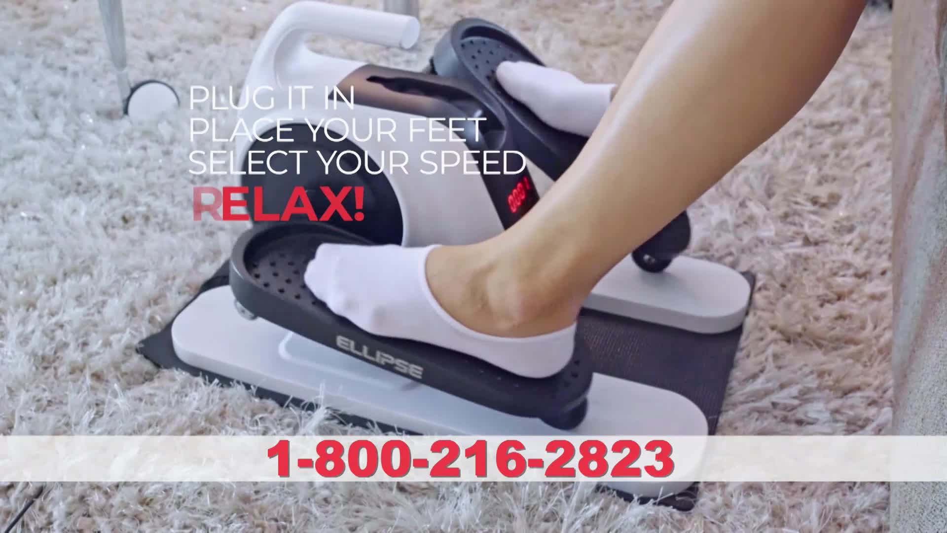 White-socked feet glide back and forth on the black pedals of a compact elliptical machine. The machine rests on a plush, cream-colored carpet.