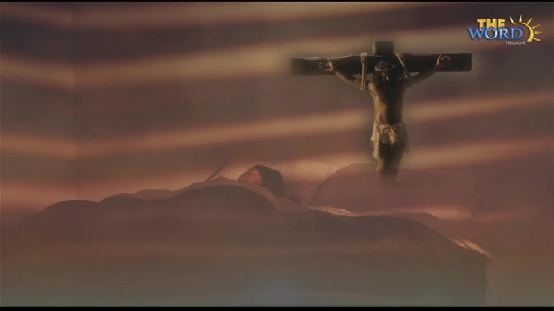 A figure hangs on a cross, silhouetted against a dusky sky. The Word Network logo is in the top right corner, and the scene feels like a dramatic depiction of a religious event.
