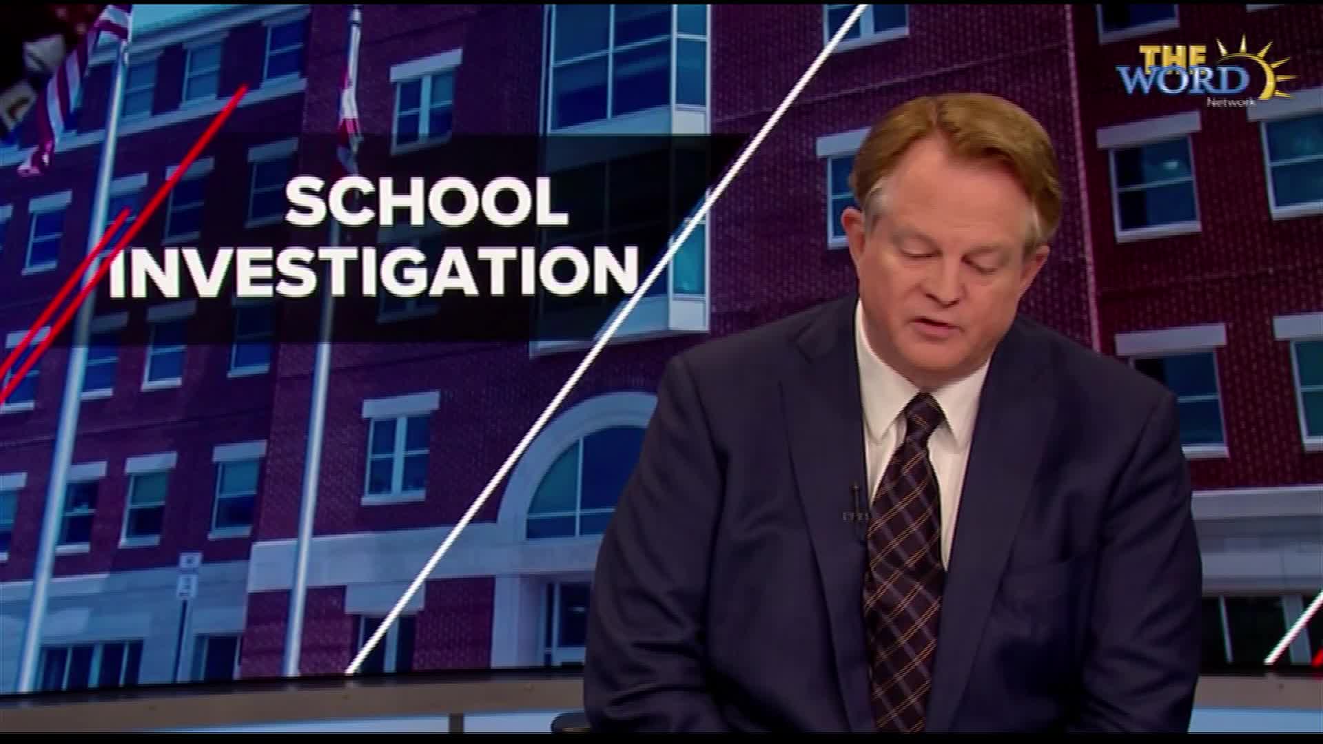 A man in a suit is reading from a script, the "School Investigation" graphic behind him on The Word Network. The backdrop shows a brick building, likely a school in the United States.
