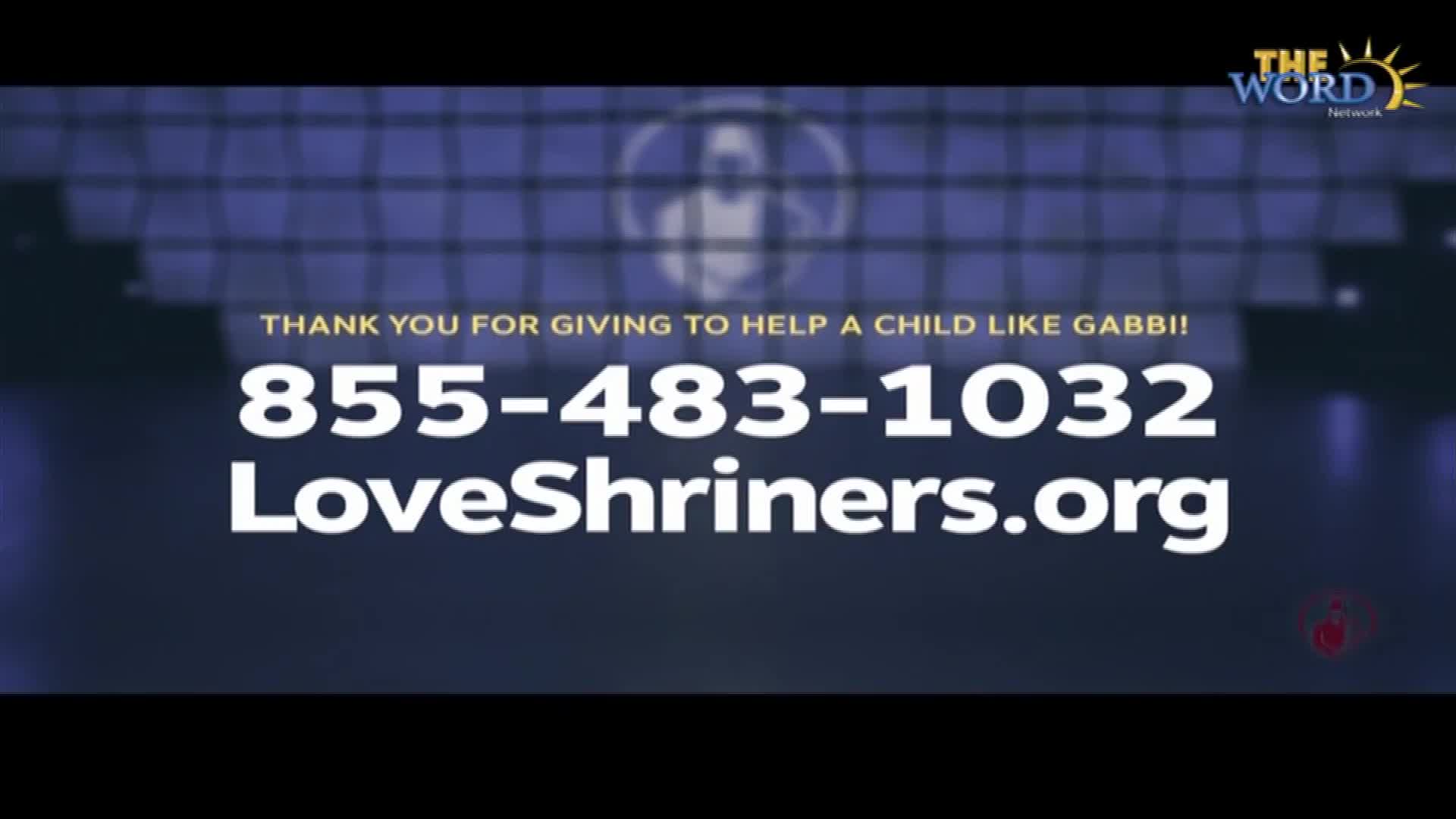 On the screen, a phone number and website for LoveShriners are displayed in large, white text. The Word Network logo sits in the upper right corner, and the background has a blurred, blue grid pattern.
