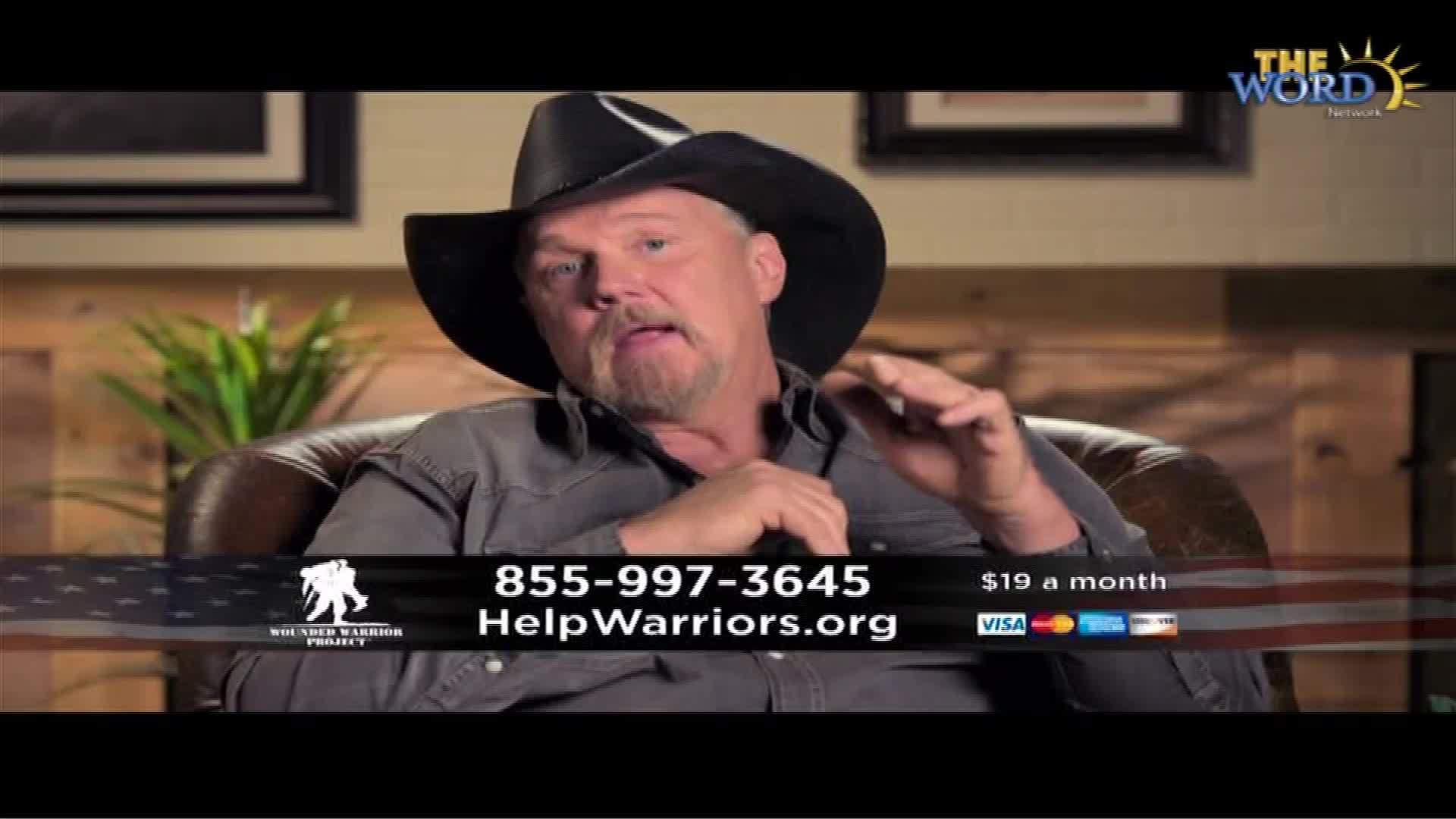 A man in a cowboy hat is seated, gesturing with his hands as he speaks. The Word Network logo is visible in the corner, and a banner promoting a veterans' support project runs across the bottom.
