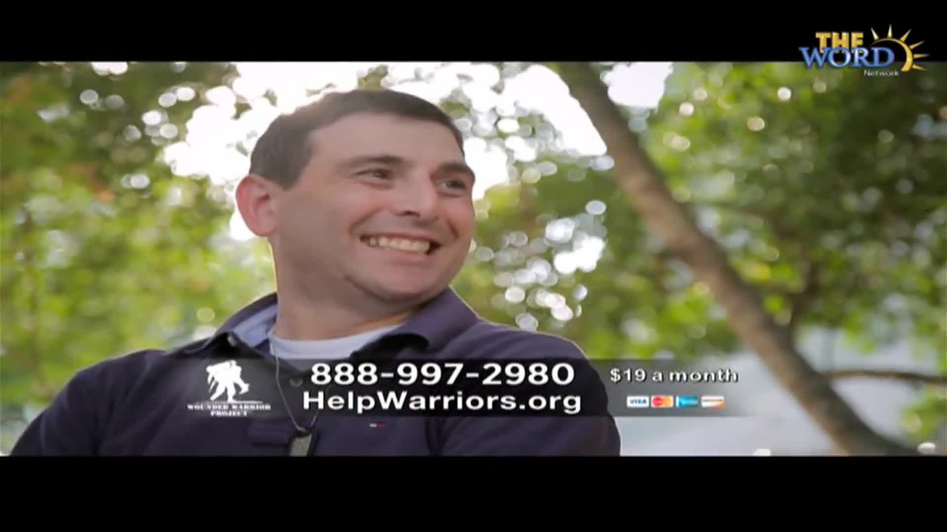 A man smiles broadly, his face lit by sunlight filtering through the trees. Beneath him, a graphic on The Word Network advertises support for veterans.
