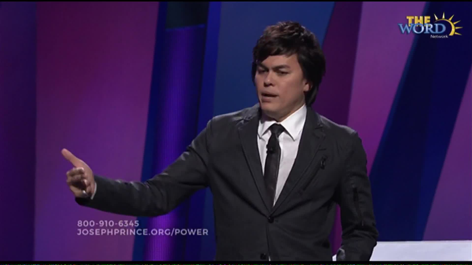 A man in a dark suit and tie gestures with his left hand. The Word Network logo appears in the upper right corner.