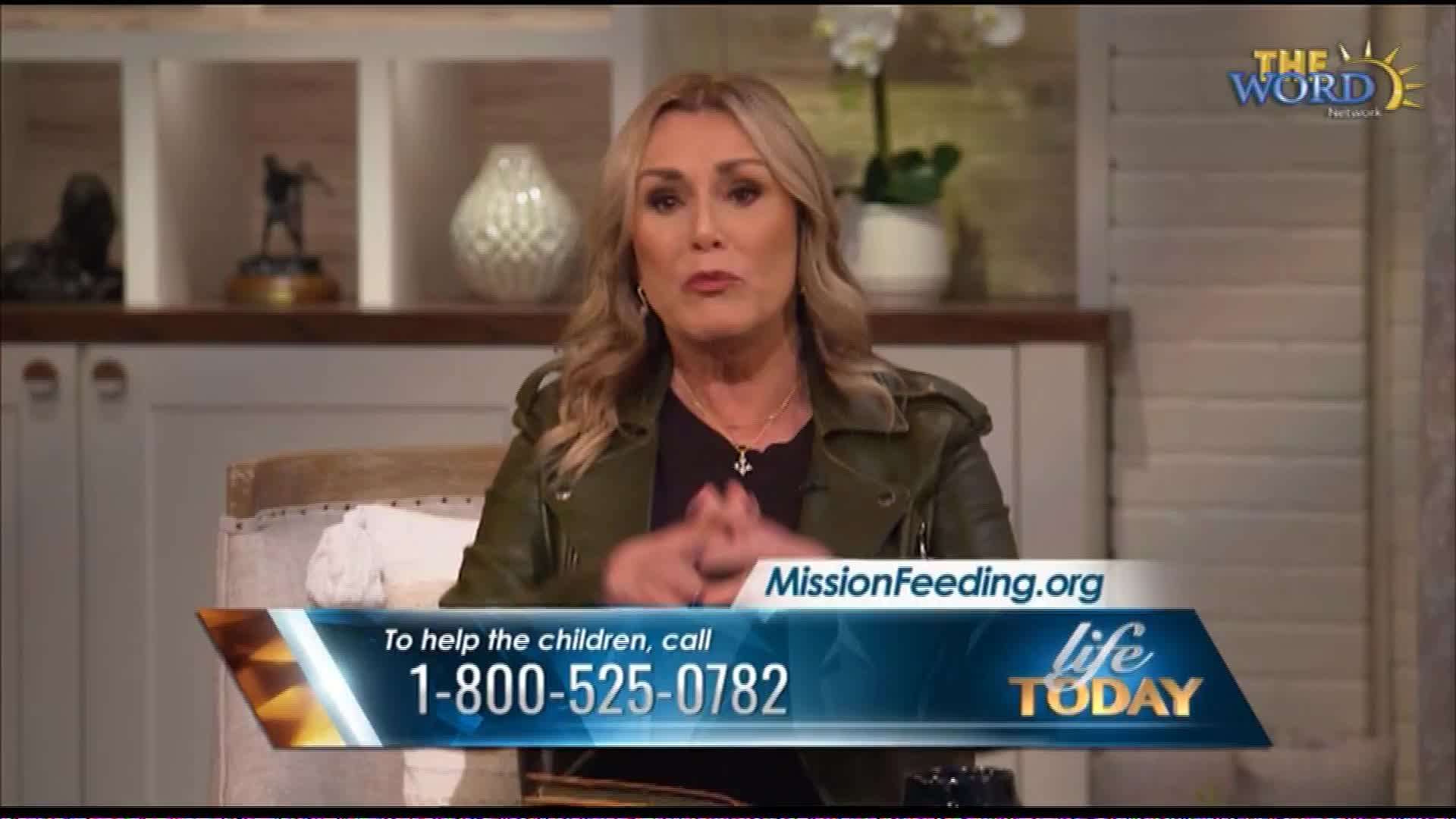 A woman speaks directly to the camera, her hands clasped in front of her. A graphic overlay displays "MissionFeeding.org" and a phone number for "Life Today," a program on The Word Network.