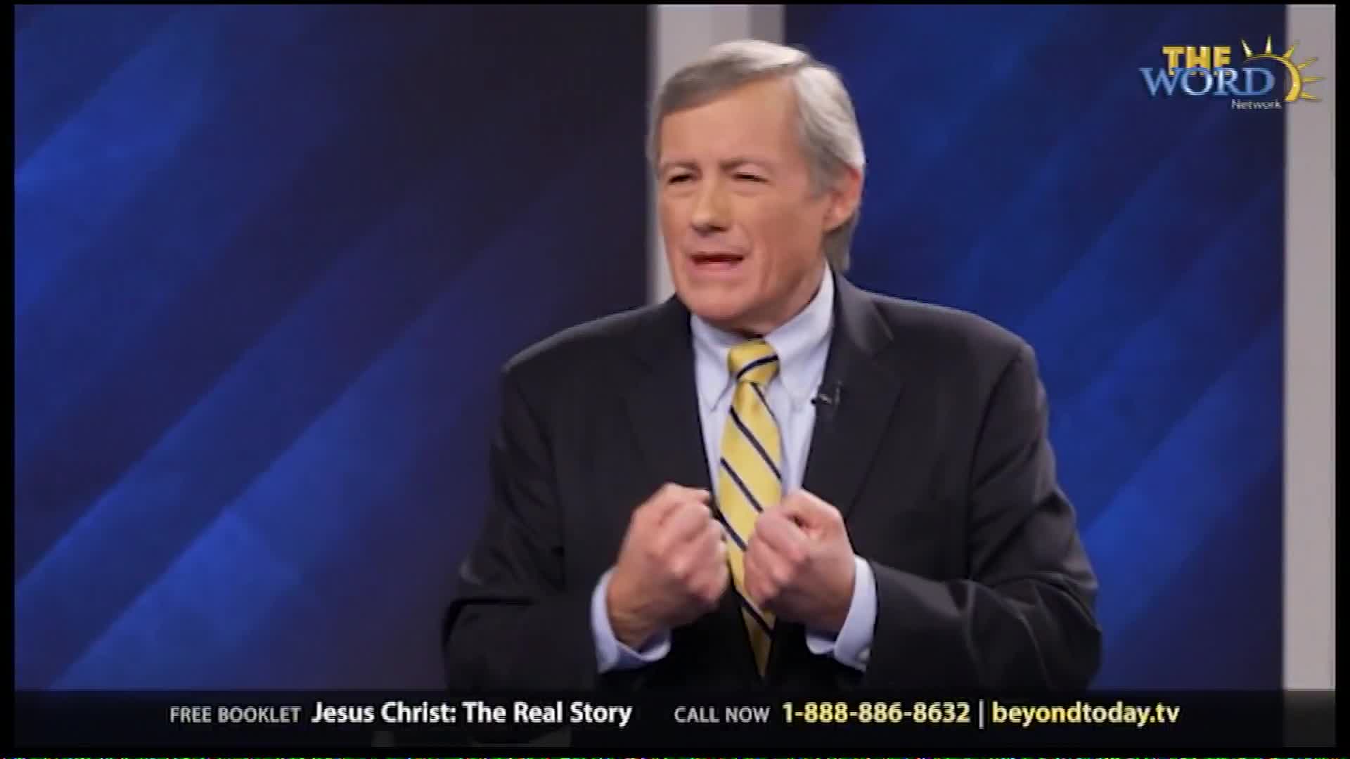 A man in a suit and tie speaks with his fists clenched, his expression intense. The Word Network logo appears behind him, and a phone number for "Jesus Christ: The Real Story" is displayed at the bottom.