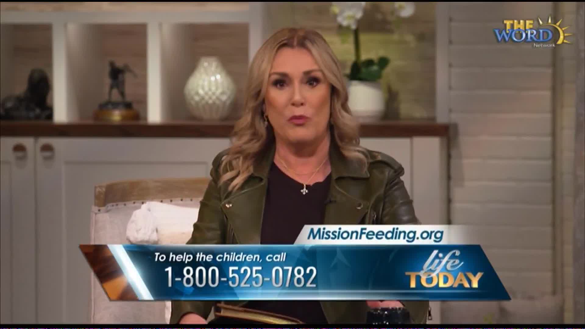 A woman speaks directly to the camera, her expression earnest. A graphic on screen displays "MissionFeeding.org" and a phone number to help children.