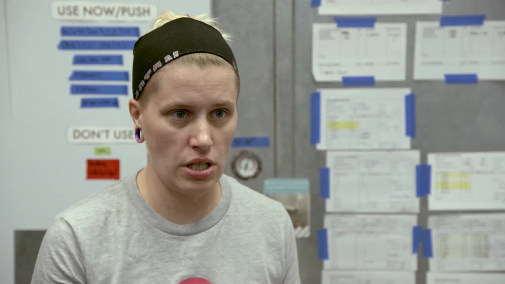 A woman with short blonde hair and a black headband is speaking, her mouth open. She's in a room with papers taped to the wall behind her, likely on a VICE TV show.
A woman with short blonde hair and a black headband is speaking, her mouth open. She's in a room with papers taped to the wall behind her, likely on a VICE TV show.