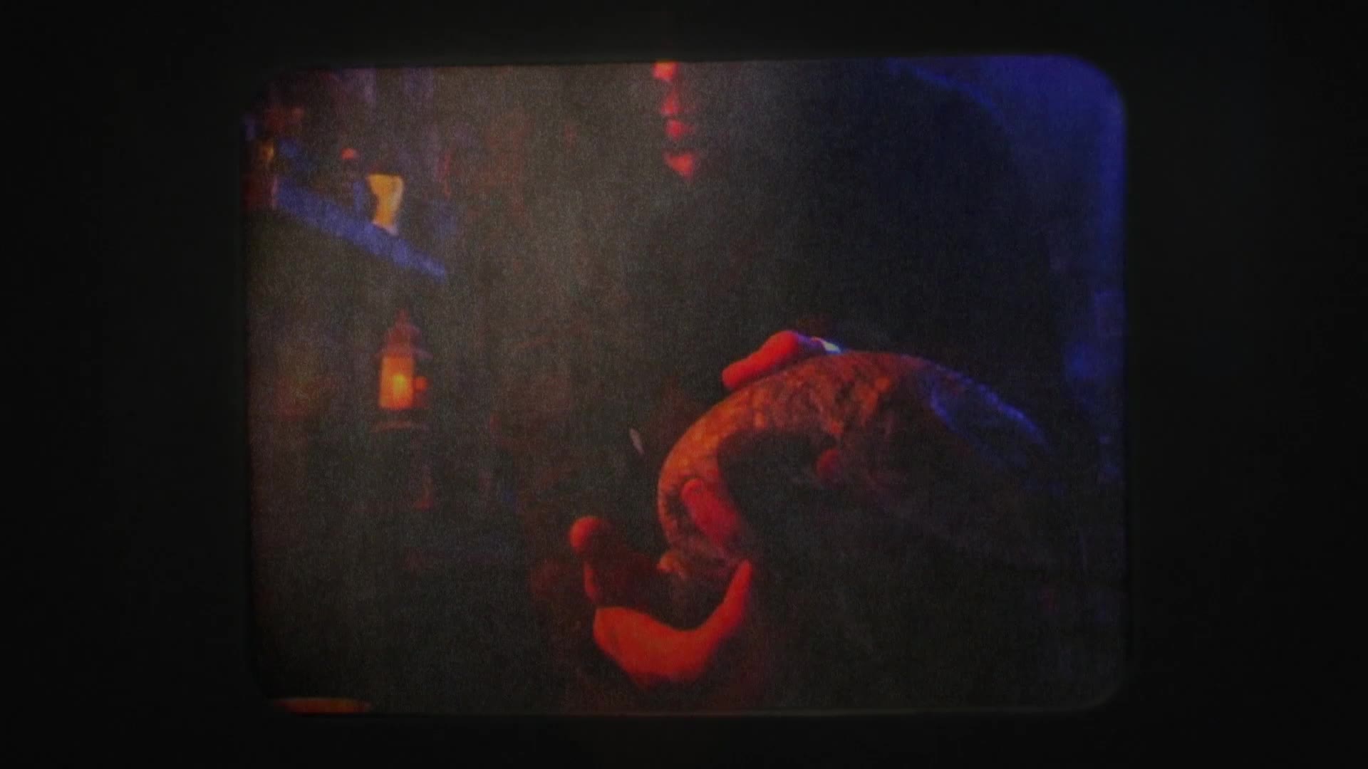 A person's hands, illuminated by a warm, orange glow, cradle what looks like a large, textured fruit or vegetable. The scene feels like it could be from a VICE TV documentary, perhaps filmed in the American South.