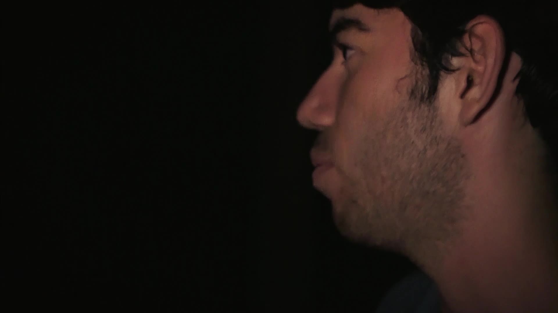 A man's profile, lit from the side, is visible against a dark background. He appears to be speaking, his mouth slightly open, as if part of a VICE TV documentary filmed in the United States.