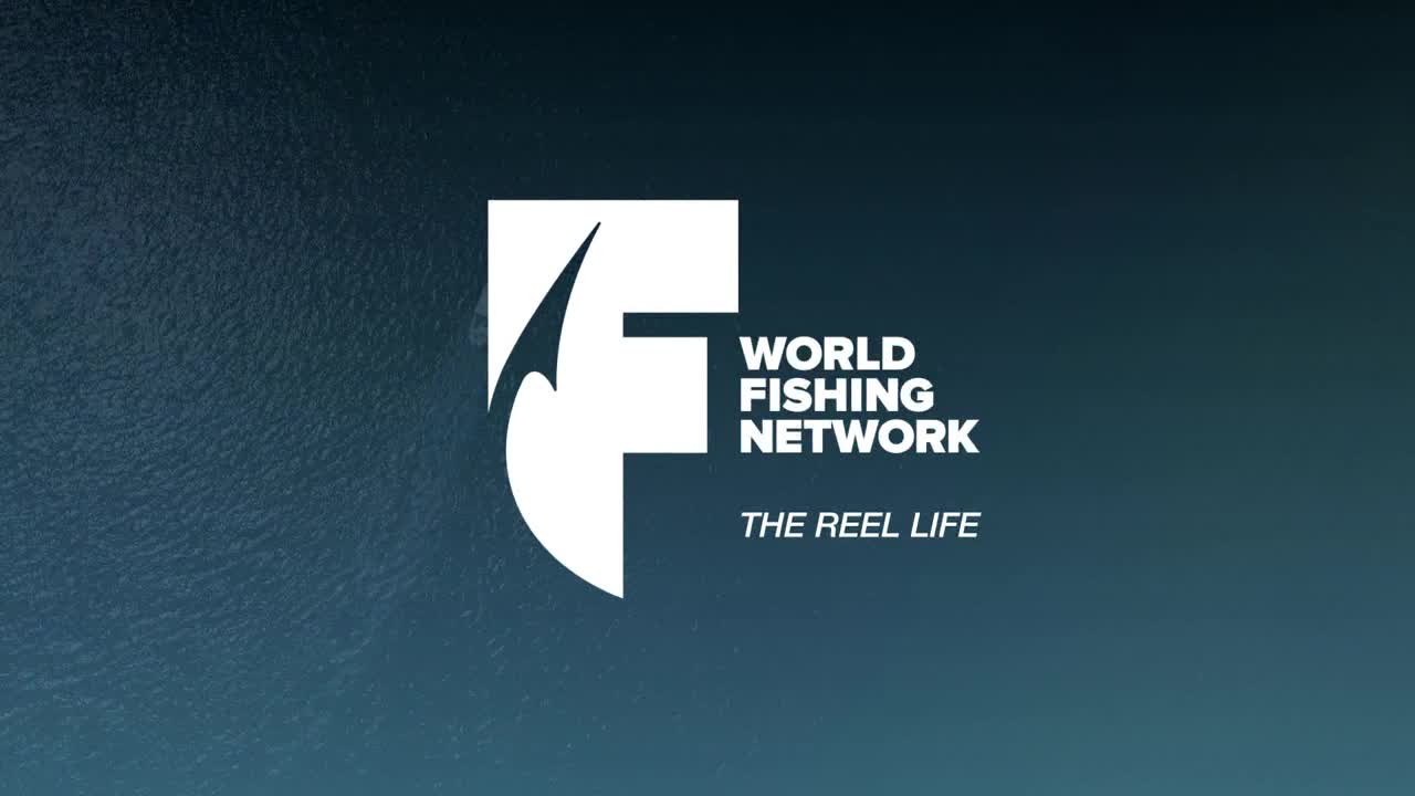 The World Fishing Network logo, a white "F" with a stylized hook, sits against a dark blue gradient background. Below, the tagline "THE REEL LIFE" is in white text.
