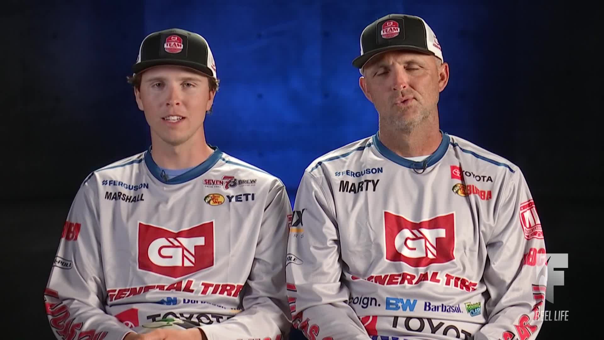 Two men wearing matching fishing jerseys and caps are seated side-by-side, facing the camera. They appear to be on the World Fishing Network, likely discussing a recent tournament.
