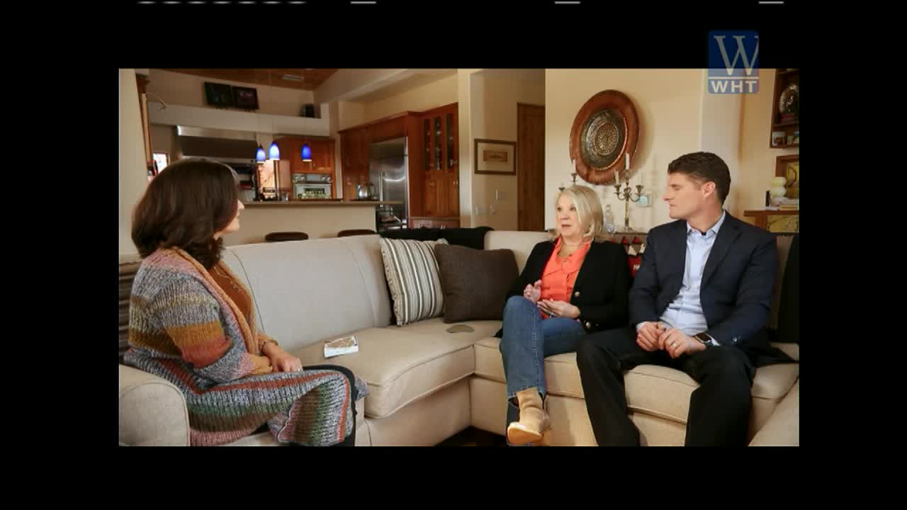 On a comfortable couch, three people are engaged in a conversation, likely for a World Harvest TV segment. The woman in the middle gestures with her hands as she speaks, while the others listen attentively.
