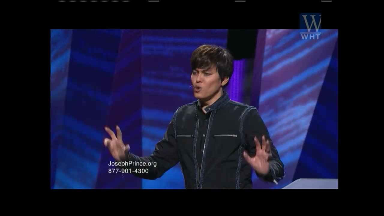 On the World Harvest TV set, a man in a black jacket gestures emphatically with both hands. His mouth is open as he speaks, and the background is a gradient of blue.
