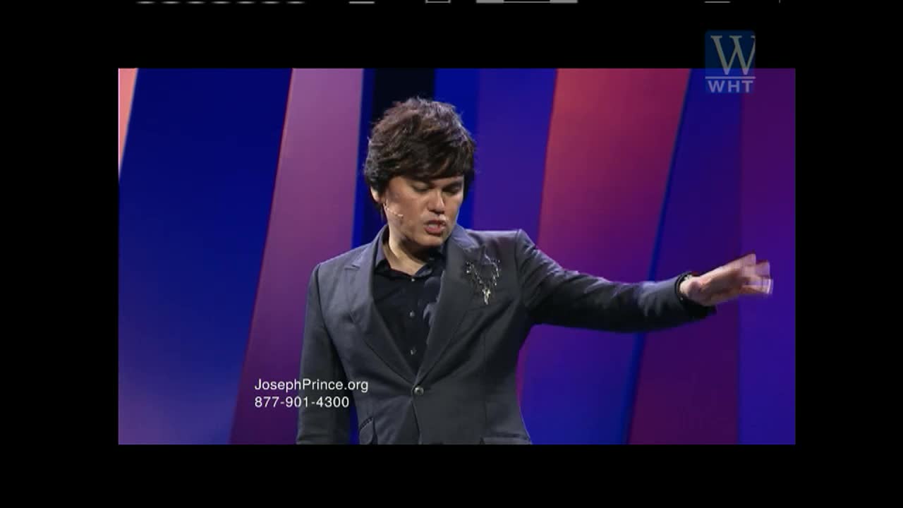 A man in a dark suit gestures with his right hand as he speaks. The World Harvest TV logo appears in the upper right corner.