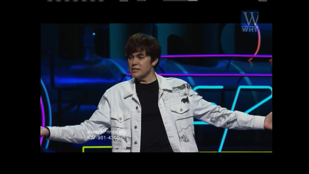A young man in a white denim jacket stands with his arms outstretched, speaking to an unseen audience. Behind him, neon lights glow in blues and purples, hinting at a stage set for a broadcast on World Harvest TV.