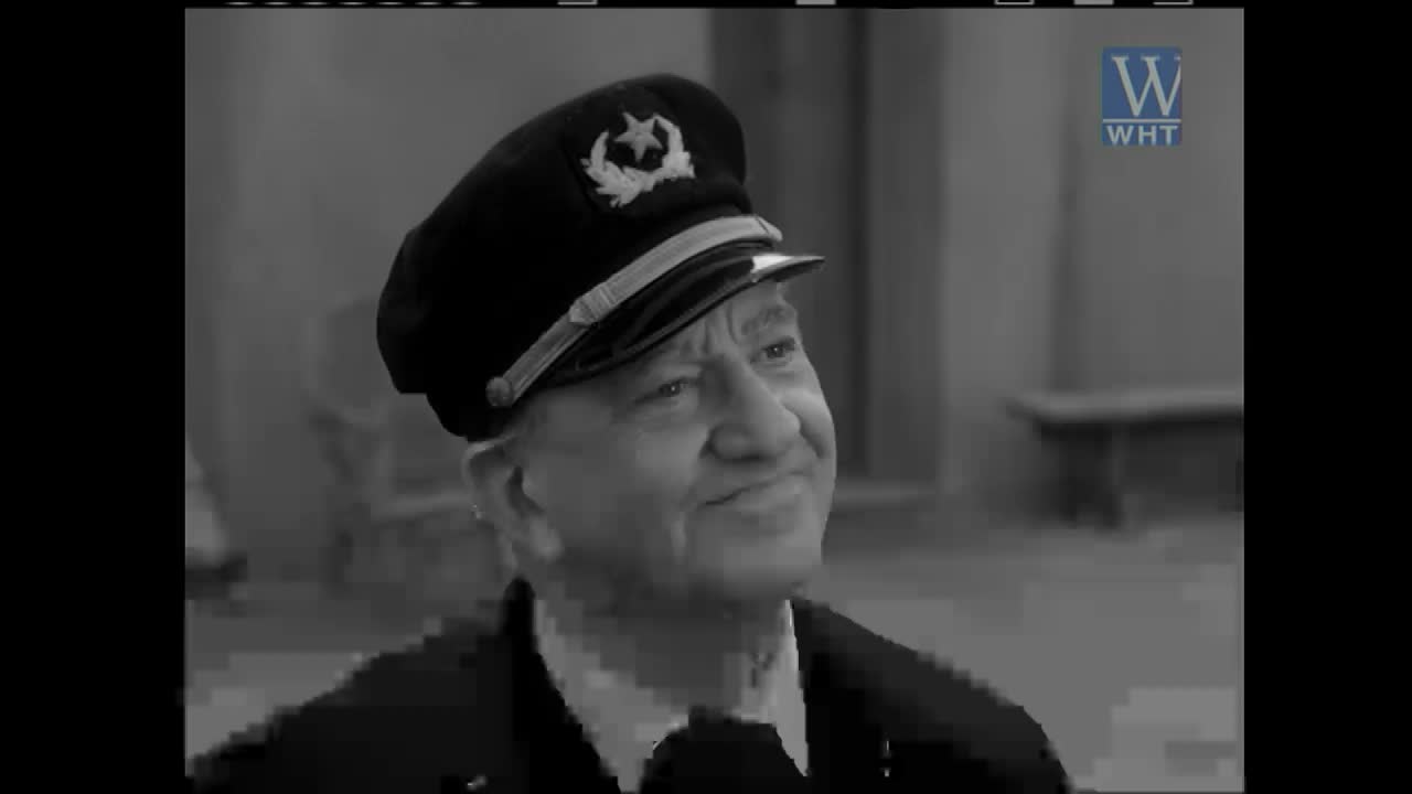 A man in a captain's hat smiles, his eyes crinkling. The World Harvest Television logo appears in the corner.