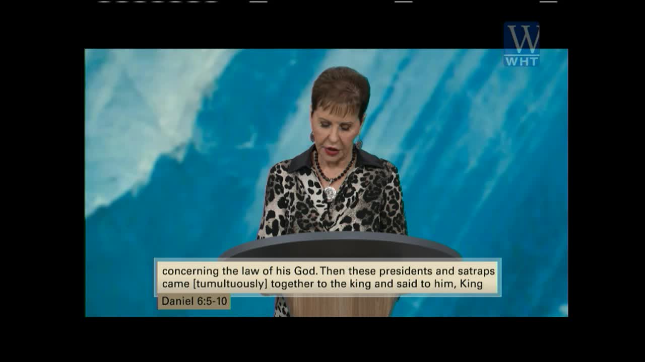 A woman stands at a podium on a stage, reading from a Bible verse displayed on a screen. The World Harvest Television logo appears in the upper right corner.