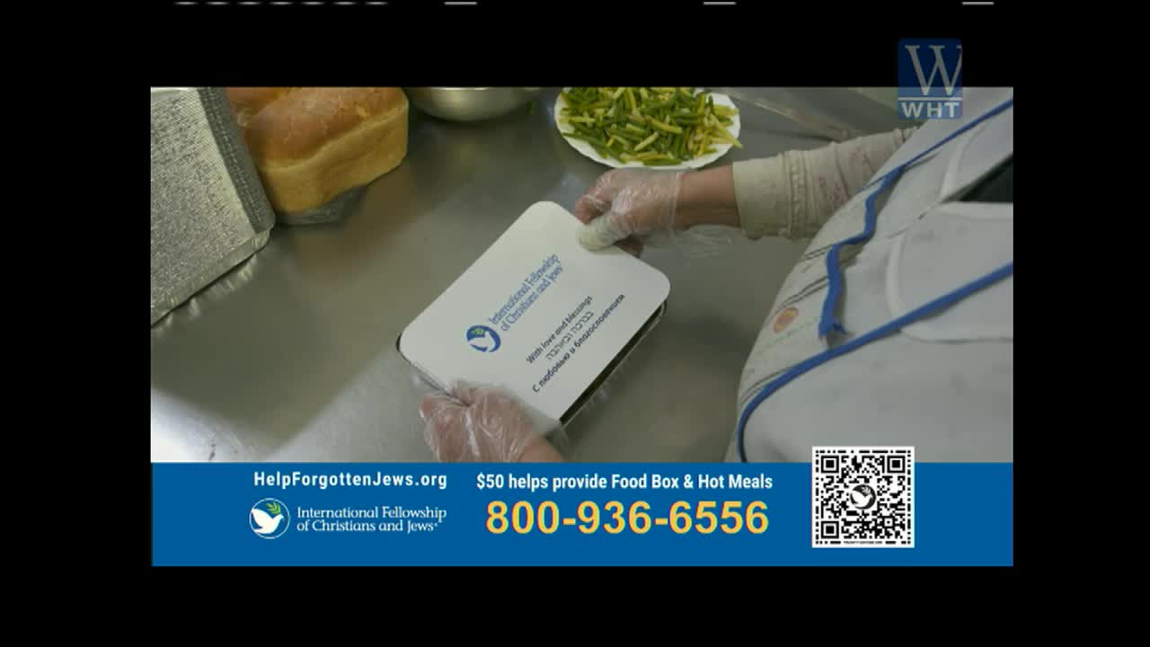 Gloves on, a person seals a white food container. Nearby, loaves of bread and a plate of green beans sit on a stainless steel counter.