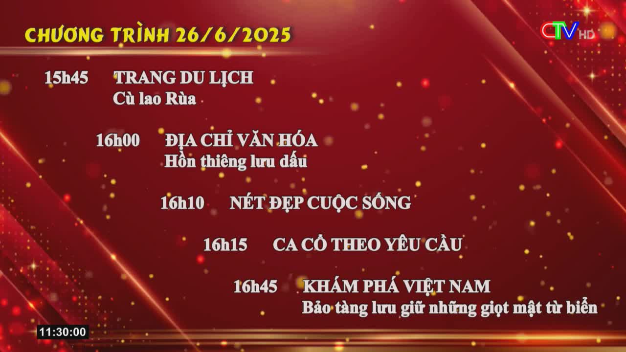 A schedule of programs flashes on the screen, listing upcoming shows on Ca Mau TV, including "Discover Vietnam" and "Culture Address." The time at the bottom reads 11:30:00, while the program listings are for the afternoon.
