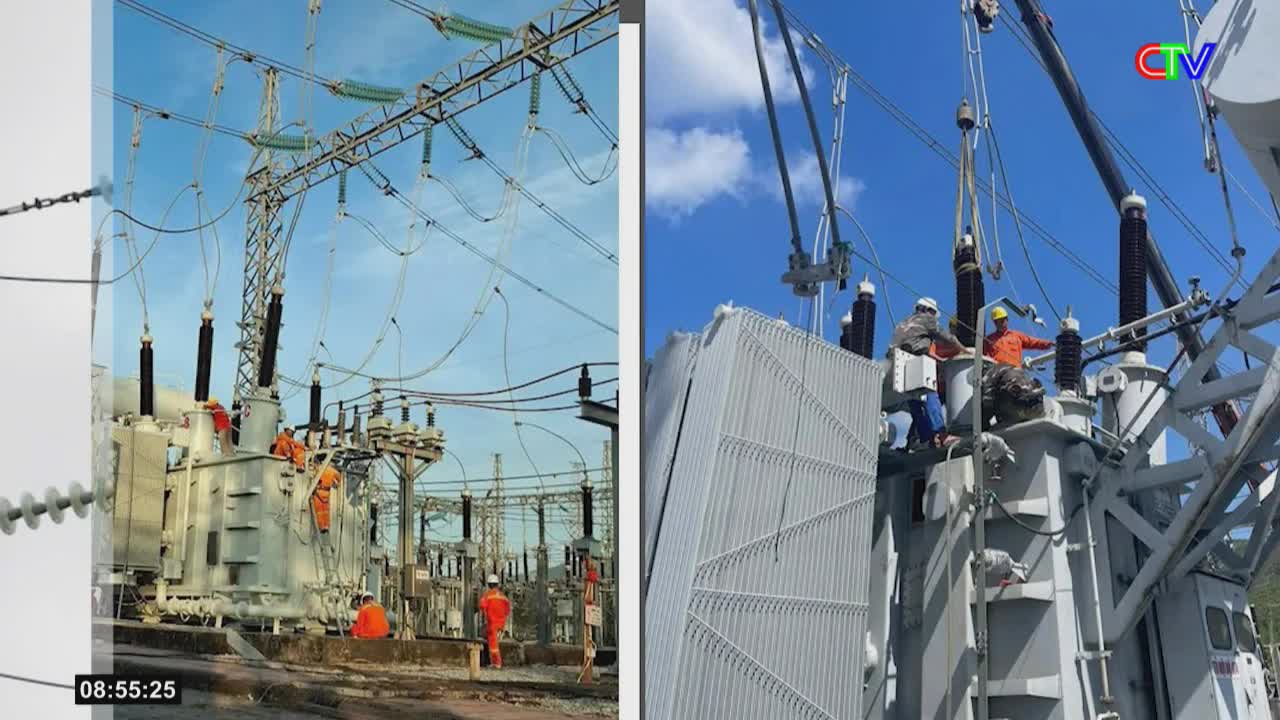 Workers in orange vests are installing a large transformer at the Ca Mau substation. Overhead lines stretch across the bright sky, connecting to the towering electrical equipment.