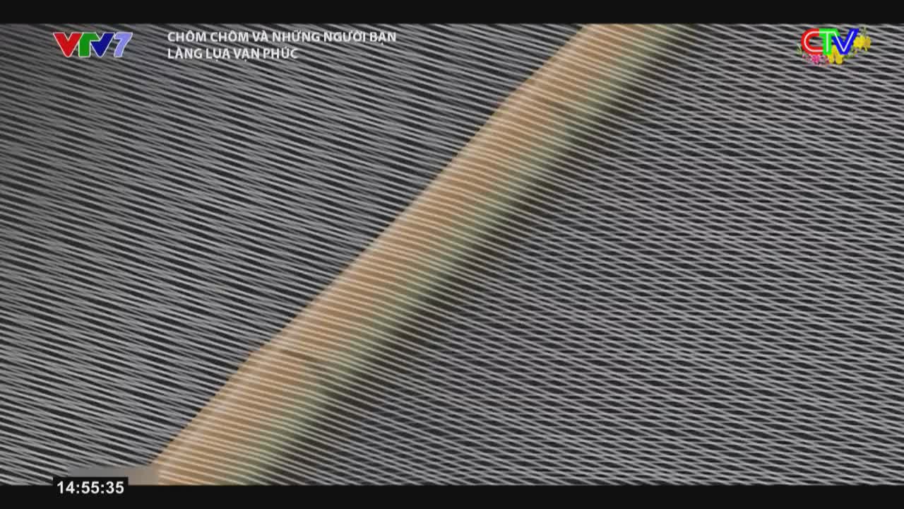 A golden band of light cuts across a field of tightly woven white threads. The threads stretch diagonally, creating a textured surface that seems to ripple.