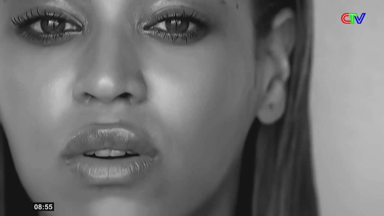 A woman's face fills the frame, her eyes and lips glistening under the lights. The Ca Mau TV logo appears in the corner, a familiar sight during broadcasts.