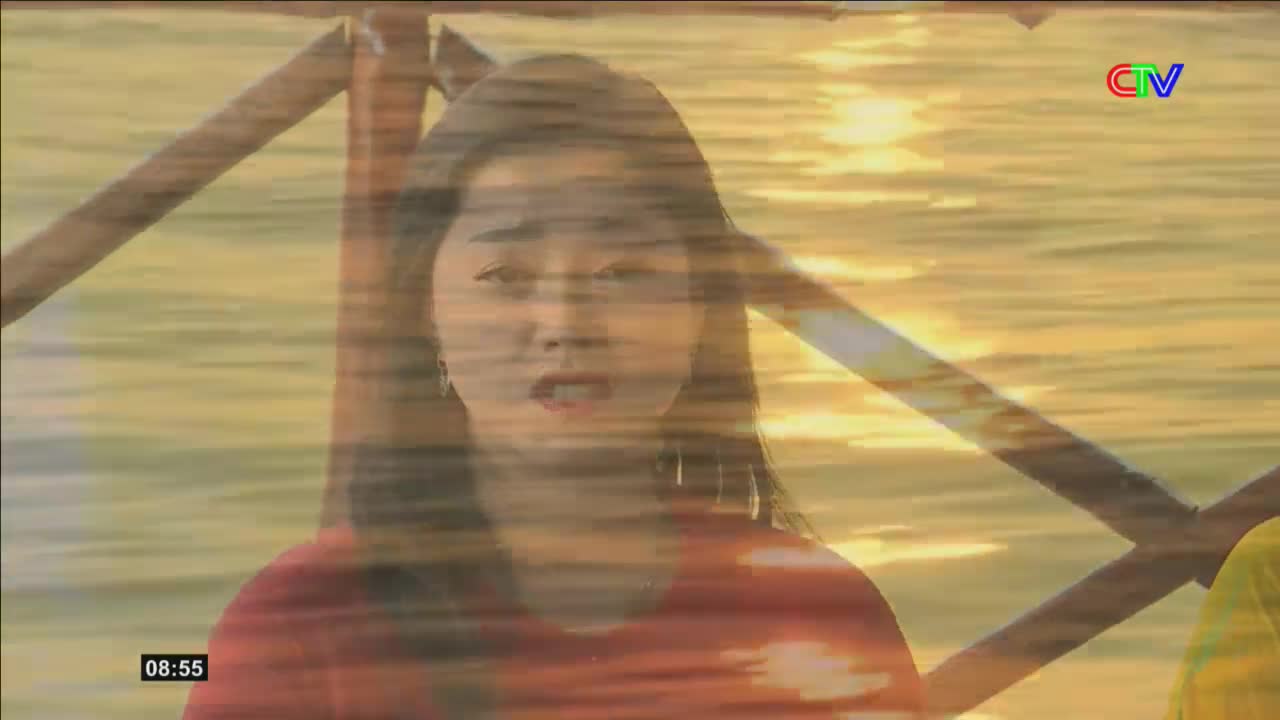 A woman's face, superimposed over a shimmering water scene, looks out from the screen. The Ca Mau TV logo appears in the upper right corner.