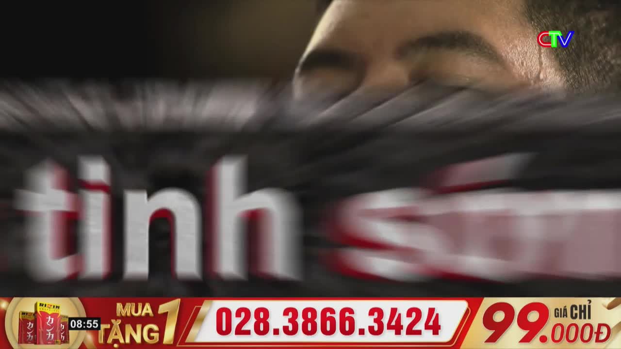 A man's face is blurred at the top, with the Ca Mau TV logo visible near his eye. Large, white Vietnamese text with red outlines rushes across the screen, partially obscuring a dark, textured background.