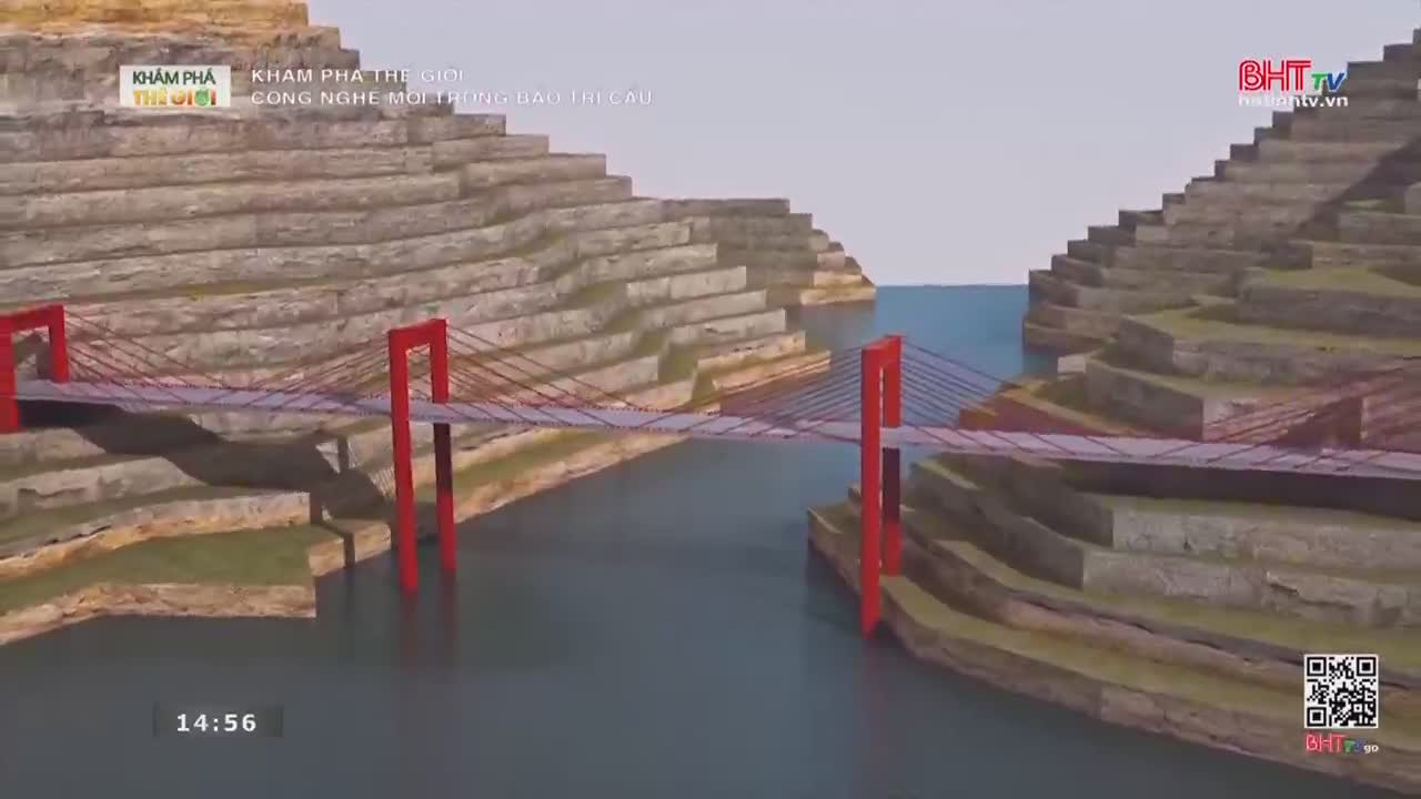 A vibrant red suspension bridge spans a wide river, its cables stretching taut between towering, stepped embankments. The water below reflects the sky, a calm expanse broken only by the bridge's shadow.