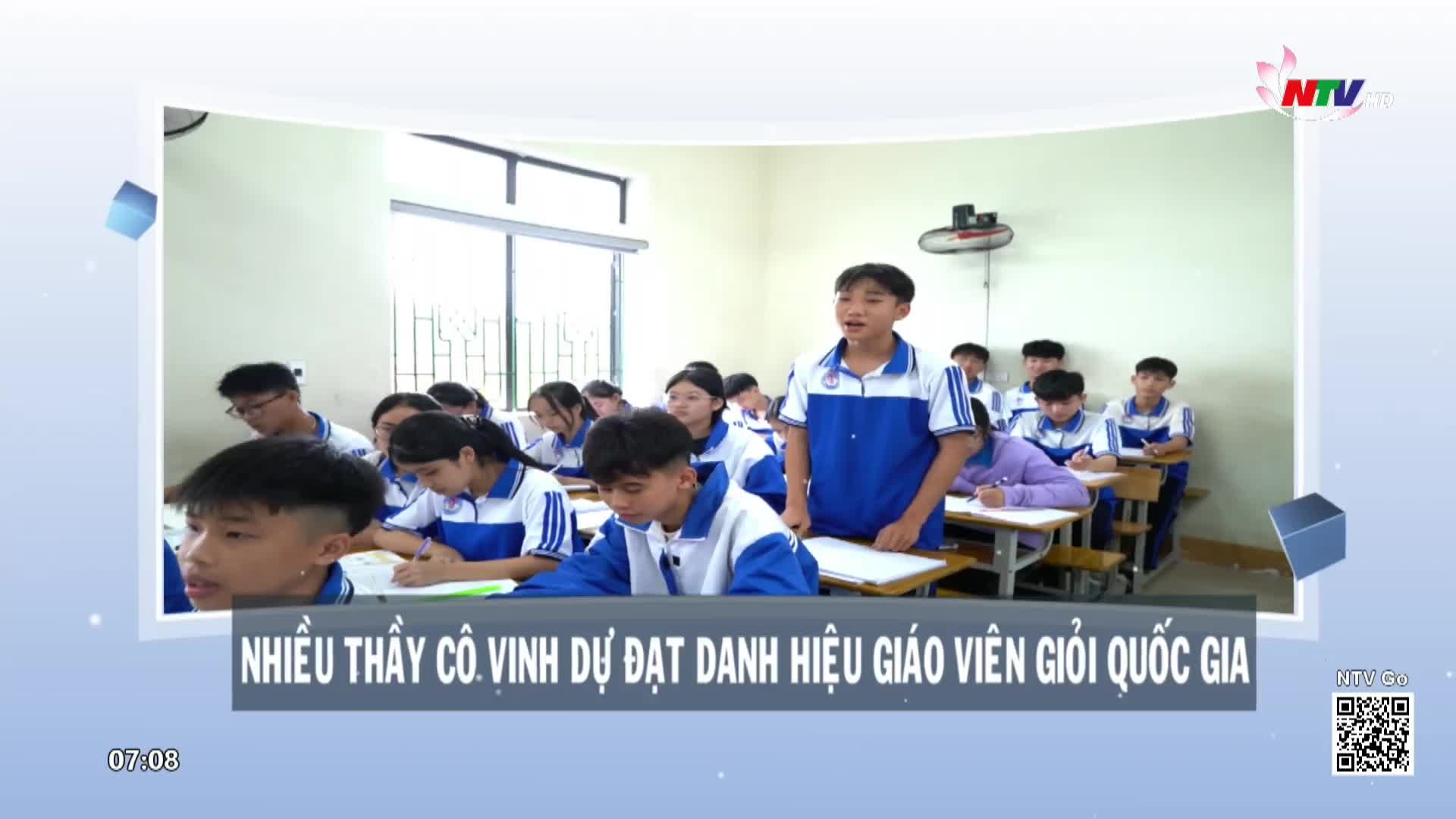 A student in a blue and white uniform stands at the front of the classroom, speaking. Other students, also in uniform, are seated at their desks, some writing.
A student in a blue and white uniform stands at the front of the classroom, speaking. Other students, also in uniform, are seated at their desks, some writing.