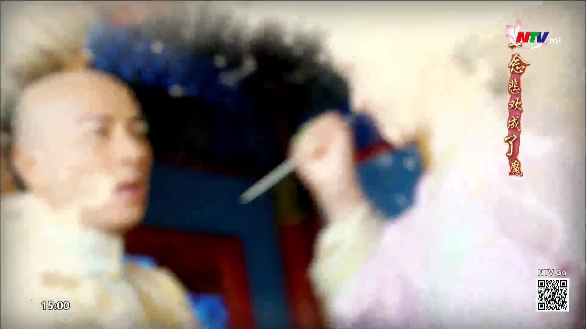 A man's face, blurred and pale, turns towards the camera. A hand holding a thin, silver object reaches into the frame from the right.