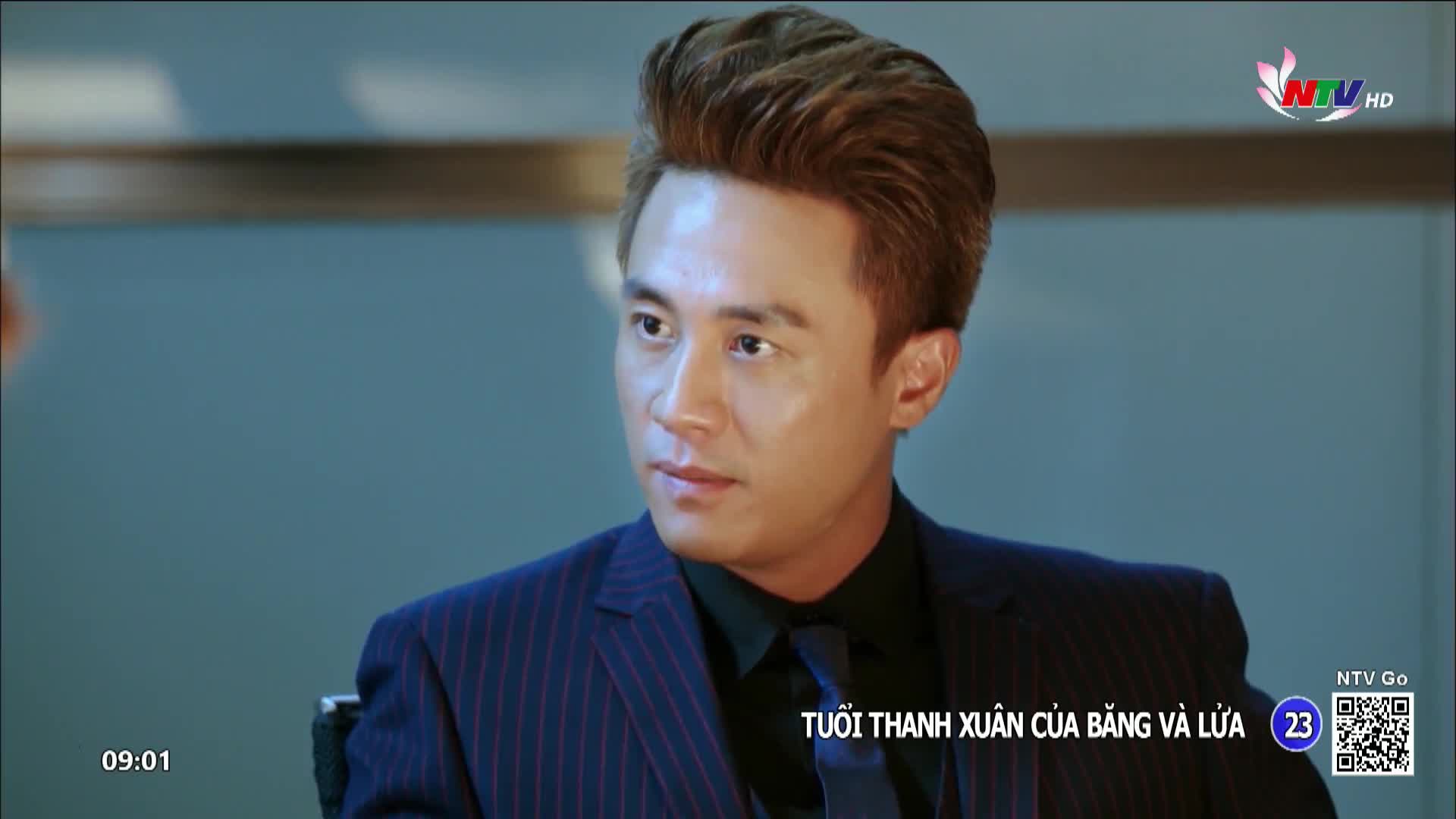 A man in a pinstripe suit turns his head, his gaze fixed off-camera. The Nghe An TV logo is visible in the upper right corner.