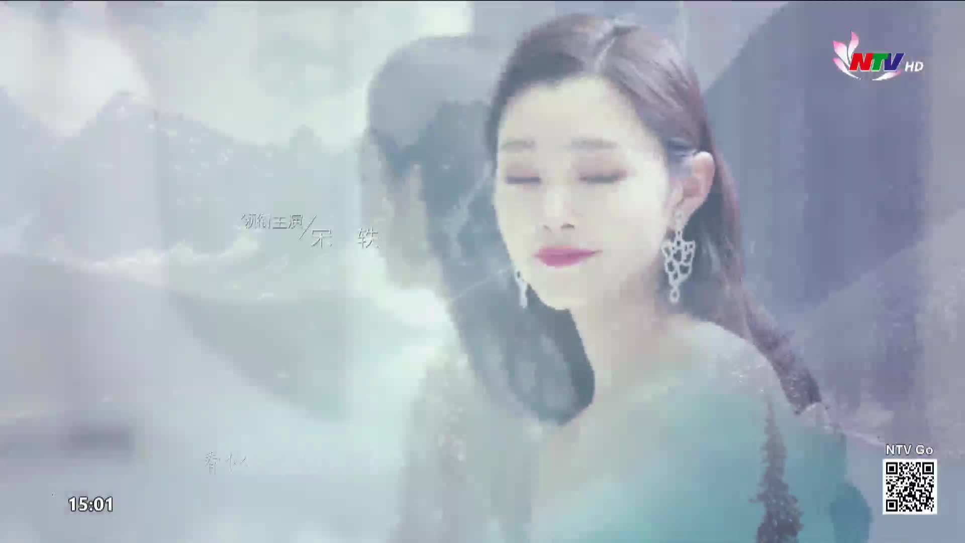 A woman with closed eyes and ornate earrings is reflected in a shimmering, watery surface. The NTV HD logo is visible in the upper right corner.