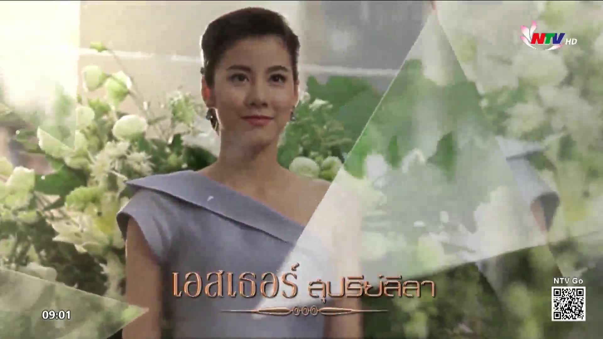 A young woman in a pale blue dress stands with a gentle smile, surrounded by soft greenery. The NTV HD logo appears in the upper right corner, a familiar sight on screens across Vietnam.