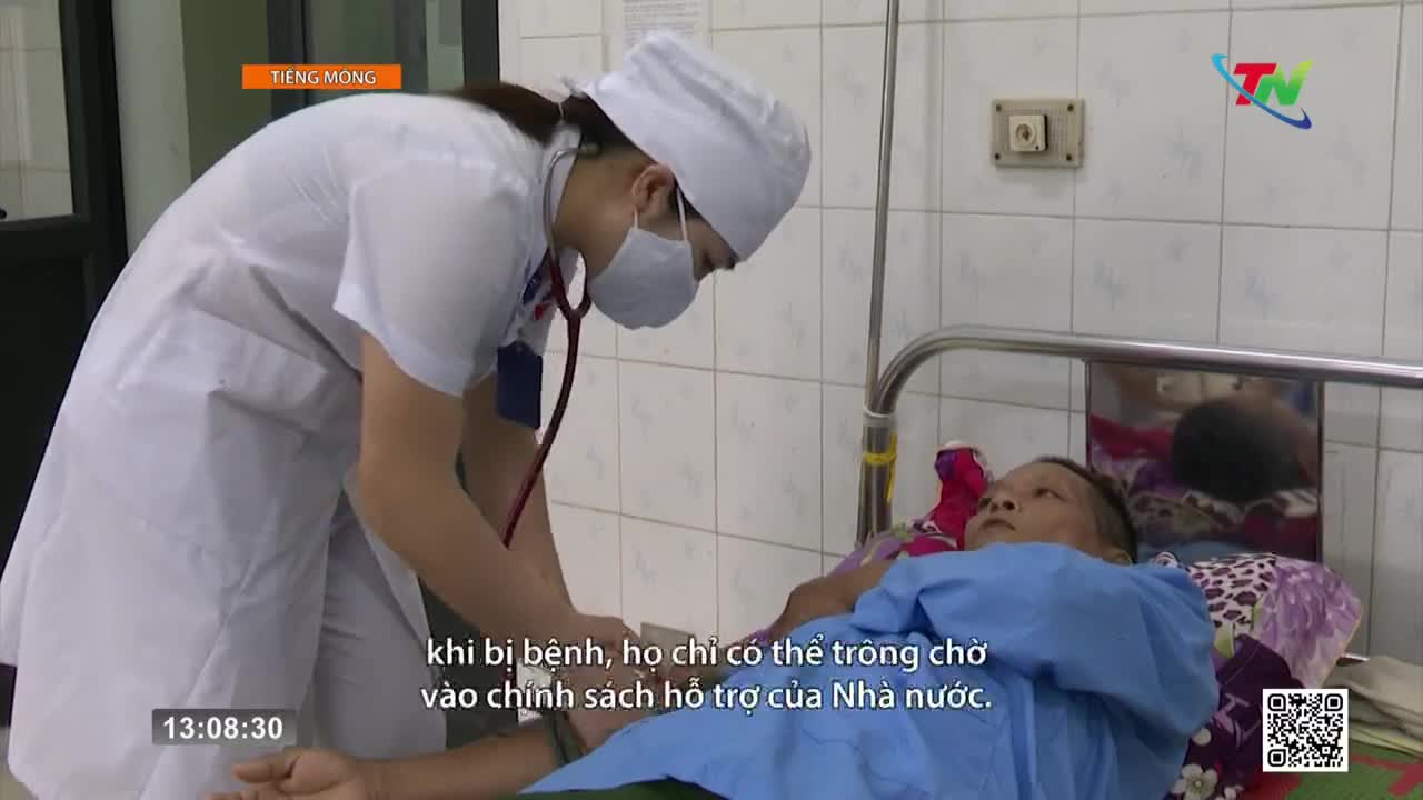A nurse in a white uniform leans over a patient in a hospital bed, listening with a stethoscope. The scene is being broadcast on Thai Nguyen TV in Vietnam.
