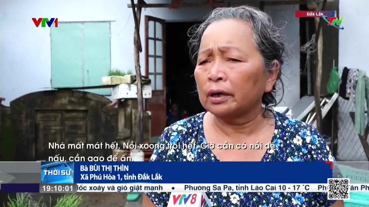 A woman with graying hair speaks directly to the camera, her words subtitled on the screen of Vietnam Television's VTV1 news program. Behind her, a damaged building and hanging laundry are visible.
A woman with graying hair speaks directly to the camera, her words subtitled on the screen of Vietnam Television's VTV1 news program. Behind her, a damaged building and hanging laundry are visible.