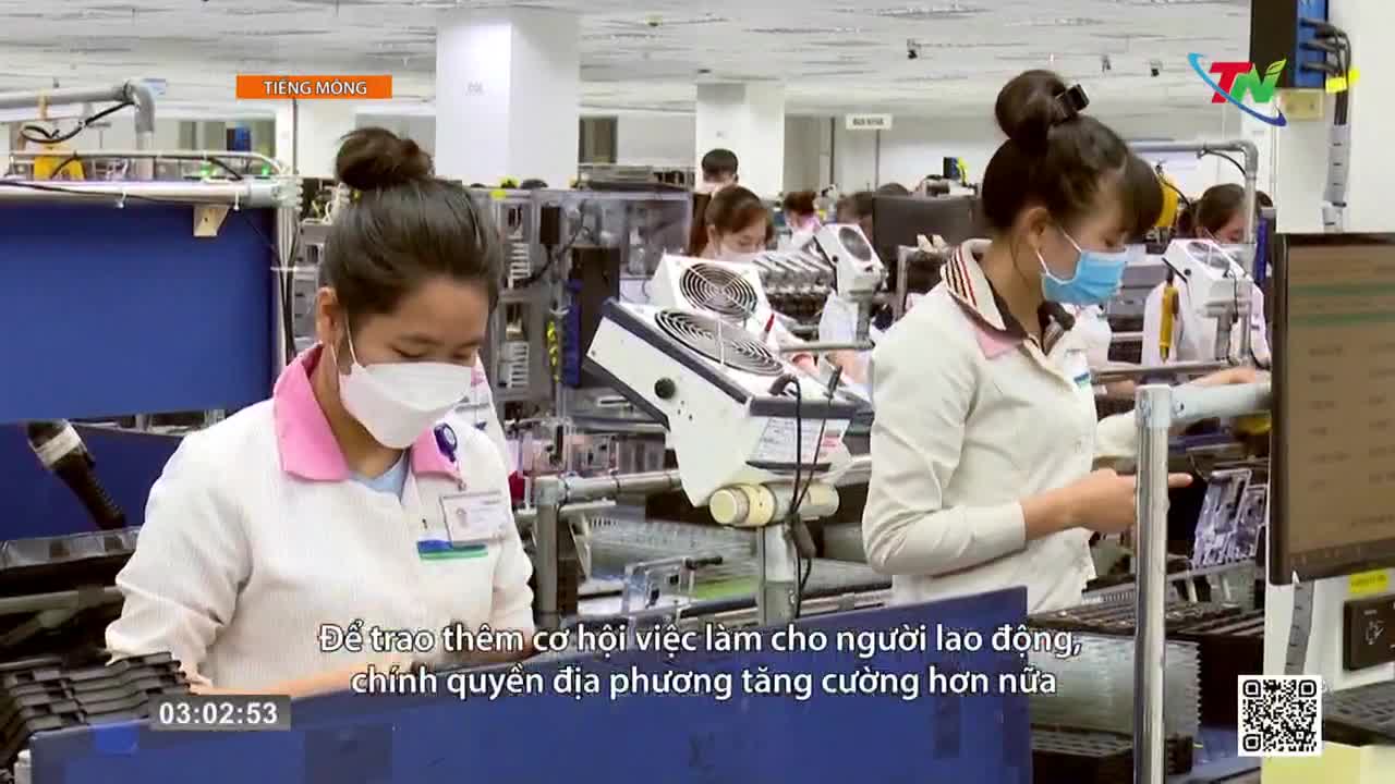 Workers in white smocks and masks lean over assembly lines, their hands busy with small components. The hum of machinery fills the air in this Thai Nguyen factory. Workers in white smocks and masks lean over assembly lines, their hands busy with small components. The hum of machinery fills the air in this Thai Nguyen factory.