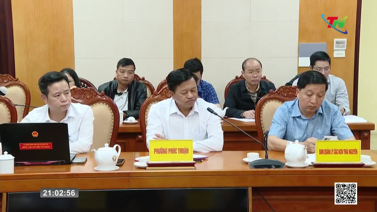 Men in a meeting room in Vietnam listen intently. The Thai Nguyen TV logo is visible in the background. Men in a meeting room in Vietnam listen intently. The Thai Nguyen TV logo is visible in the background.