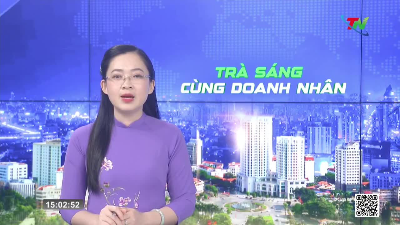 A woman in a purple áo dài speaks directly to the camera, her voice clear and steady. Behind her, a cityscape unfolds, a familiar sight from Thai Nguyen TV broadcasts.