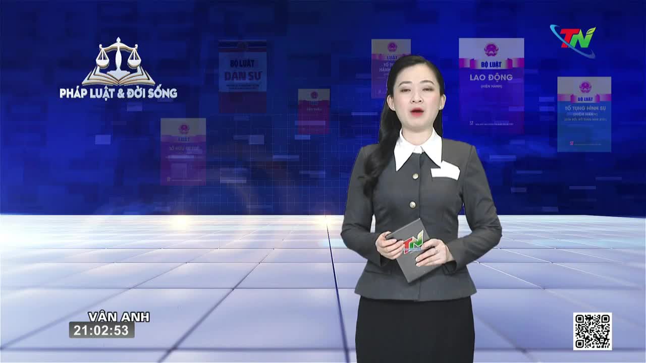 A woman in a dark suit stands before a blue background with legal texts displayed. She holds a tablet with the Thai Nguyen TV logo.