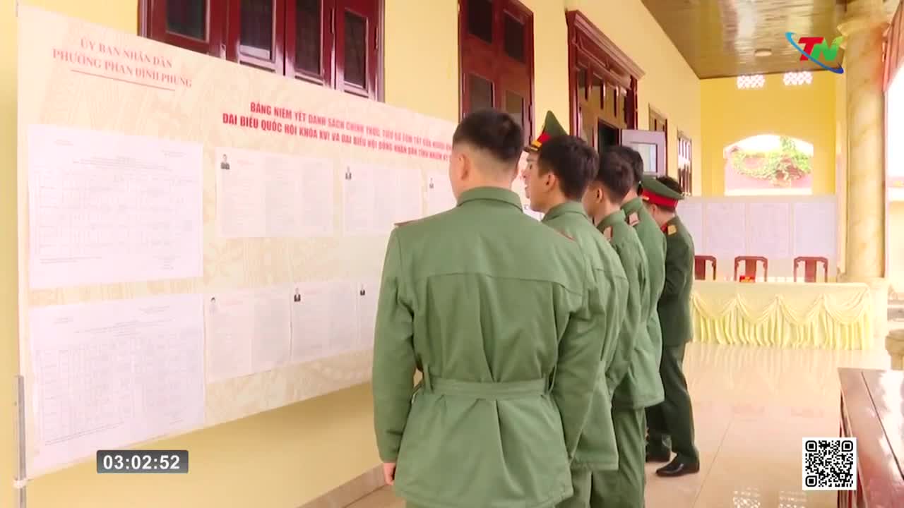 A line of soldiers in olive-green uniforms stands at attention, facing a large bulletin board covered in official documents. Their posture suggests a moment of official review or announcement.