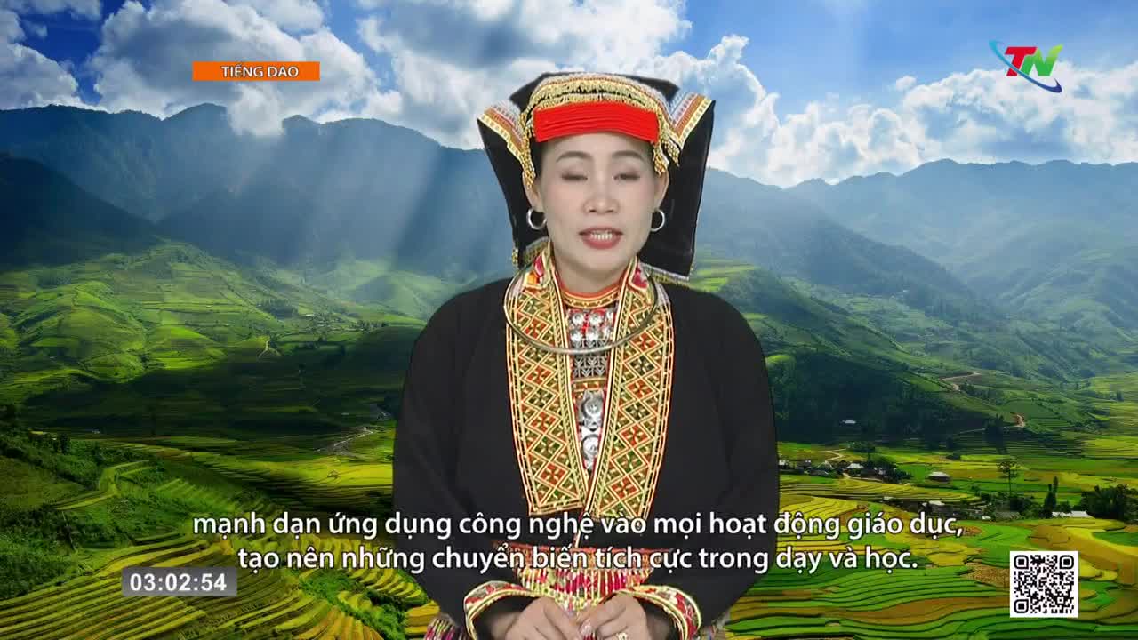A woman in traditional attire speaks, her backdrop a sweeping panorama of verdant, terraced rice paddies under a bright sky. The Thai Nguyen TV logo hovers in the corner, a subtle reminder of the broadcast.